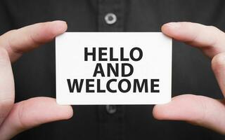businessman-holding-a-card-with-text-hello-and-welcome-business-concept-photo